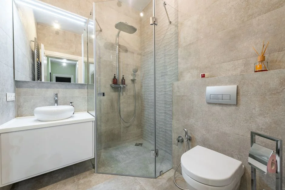 Covered with sheet sofa and floor lamp and packed cardboard boxes in light spacious room of new contemporary house